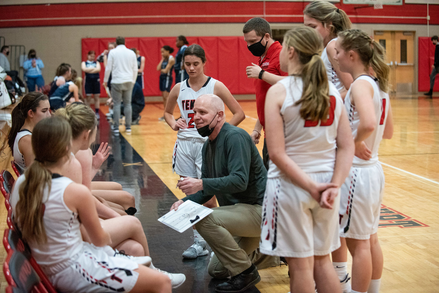 Tenino coach Scott Ashmore goes over his second-half game plan against Cascade Christian on Dec. 20.