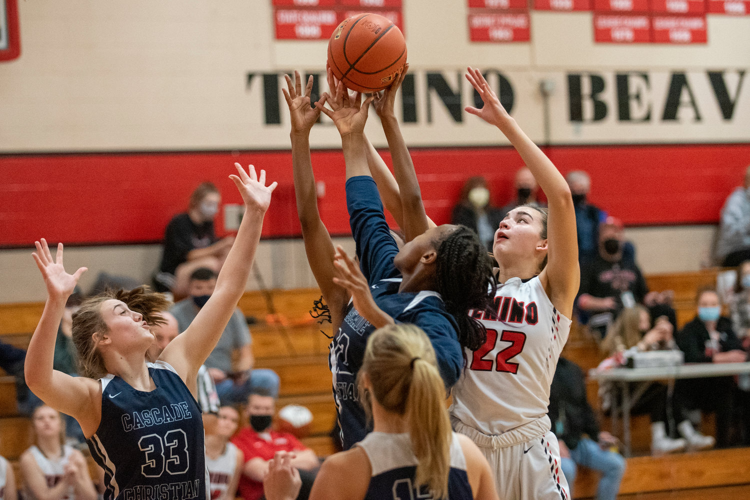 Tenino's Ashley Schow (22) battles for a rebound with Cascade Christian players on Dec. 20.