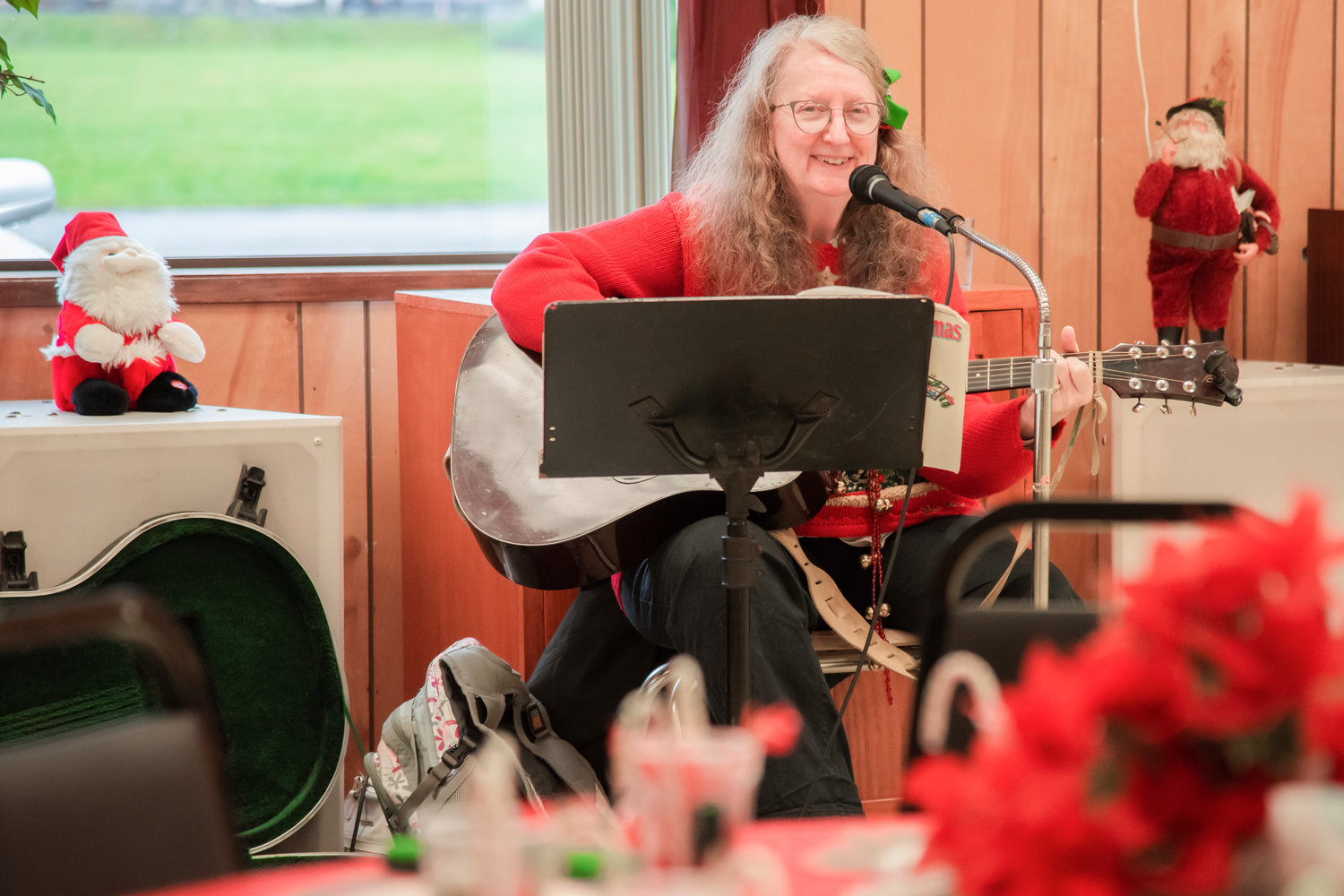 Melody Butterton smiles while playing Christmas tunes as the Morton Senior Center Wednesday afternoon.