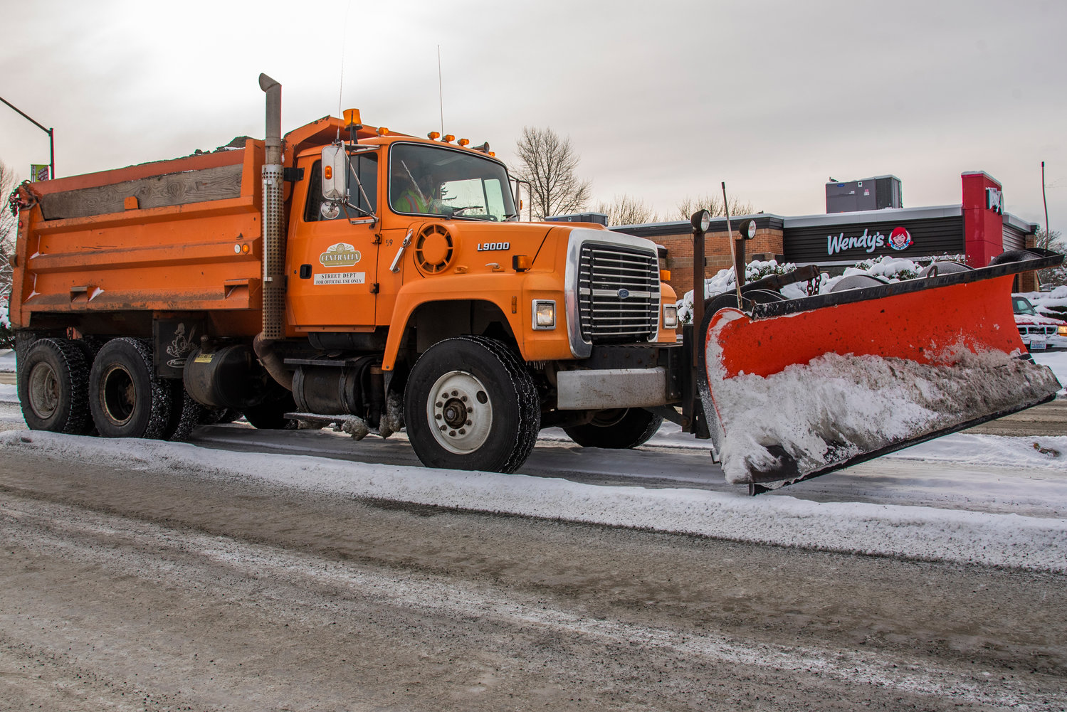 A Centralia Street Department snow plow drives down Harrison Avenue Monday morning.