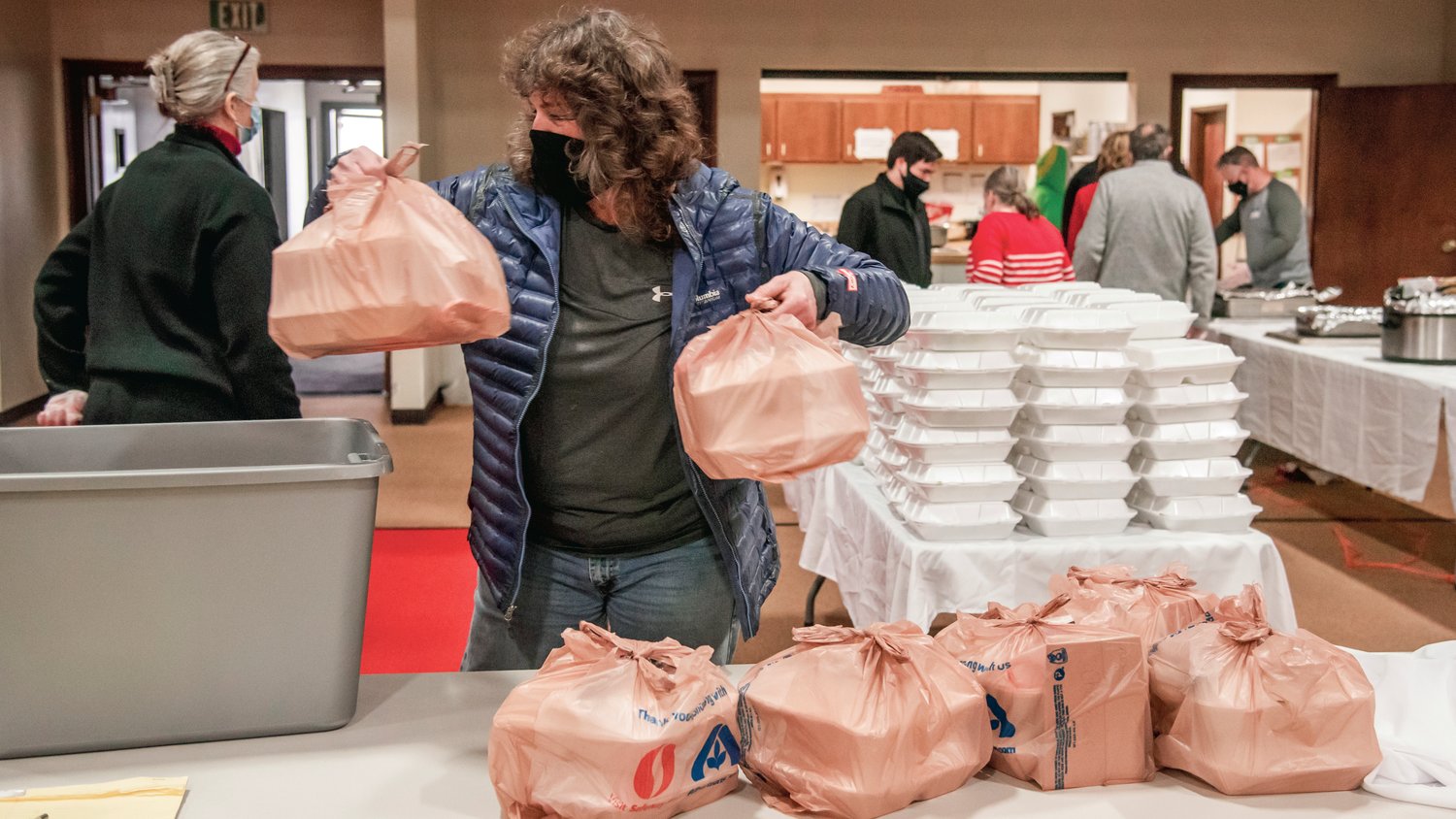 Chris Cooper grabs meals for a delivery after describing an encounter she had with a young girl who recieved a meal and said, “Maybe Christmas isn’t going to be as bad after all.”