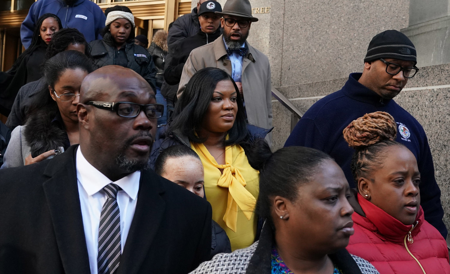 In this photo from Nov. 25, 2019, Metropolitan Correctional Center guard Tova Noel (yellow shirt) surrounded by supporters leaves Federal Court in New York City. Noel and another guard had been charged with falsifying prison records on the night Jeffrey Epstein died. (TIMOTHY A. CLARY/AFP via Getty Images/TNS)