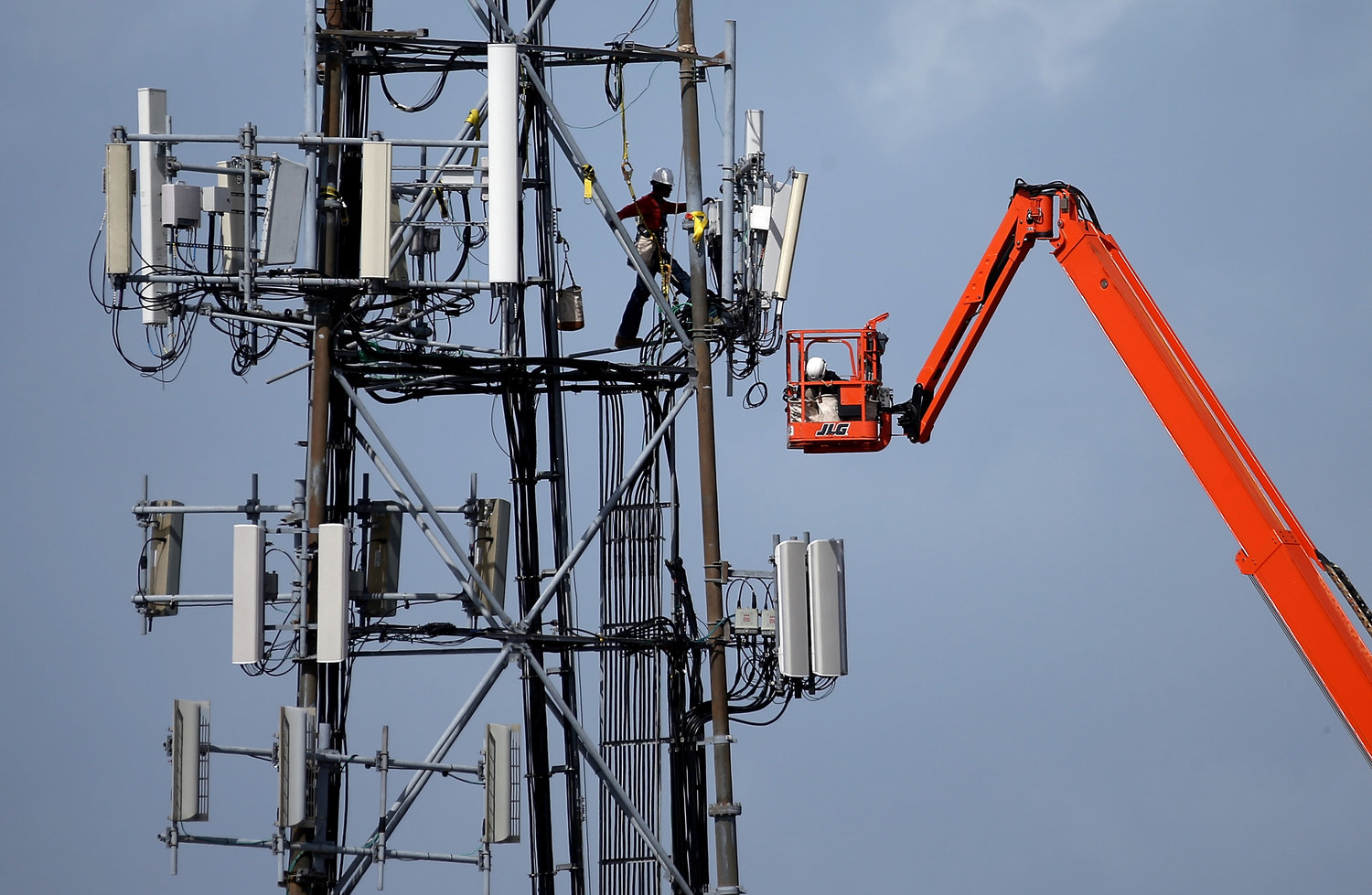 A worker on a cellular communication tower on March 6, 2014, in Oakland, California. (Justin Sullivan/Getty Images/TNS)