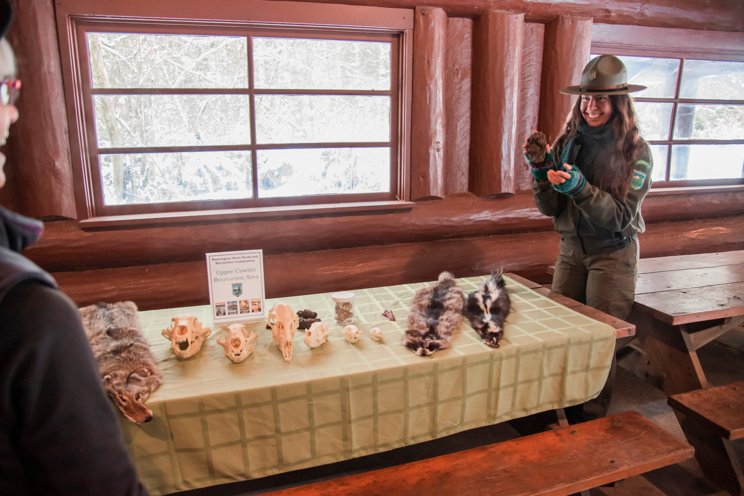 Interpretive Specialist Alysa Adams smiles while talking about mountain lion prints during a first day hike Saturday at Lewis and Clark State Park.