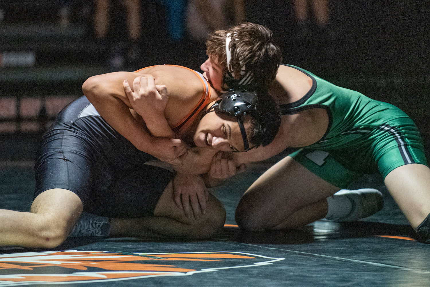Centralia senior Julian Gruginski, left, grapples with a Tumwater wrestlers at 170 pounds during a dual match in Centralia on Jan. 5.