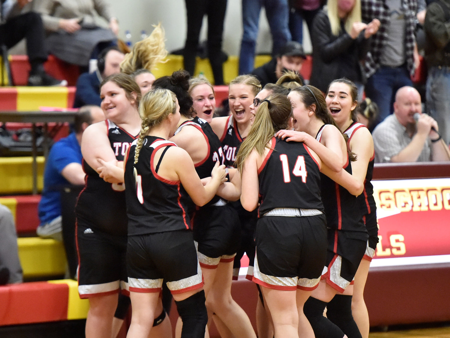 The Toledo girls basketball team celebrates after taking down the Winlock Cardinals on a 3-pointer from Rose Dillon in the final seconds on Wednesday, Jan. 5, in Winlock.