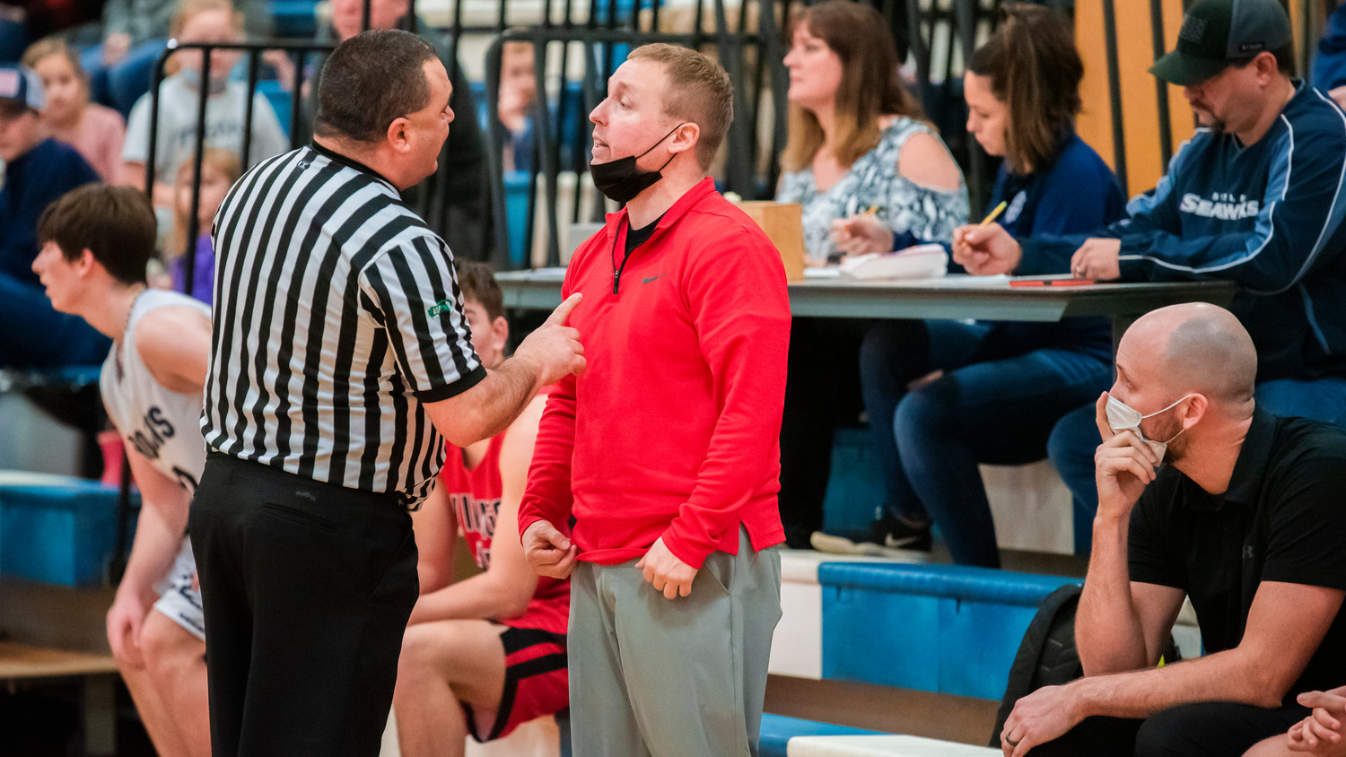 Mossyrock Head Coach Adam Deck talks to an official during a game Wednesday night in Pe Ell.