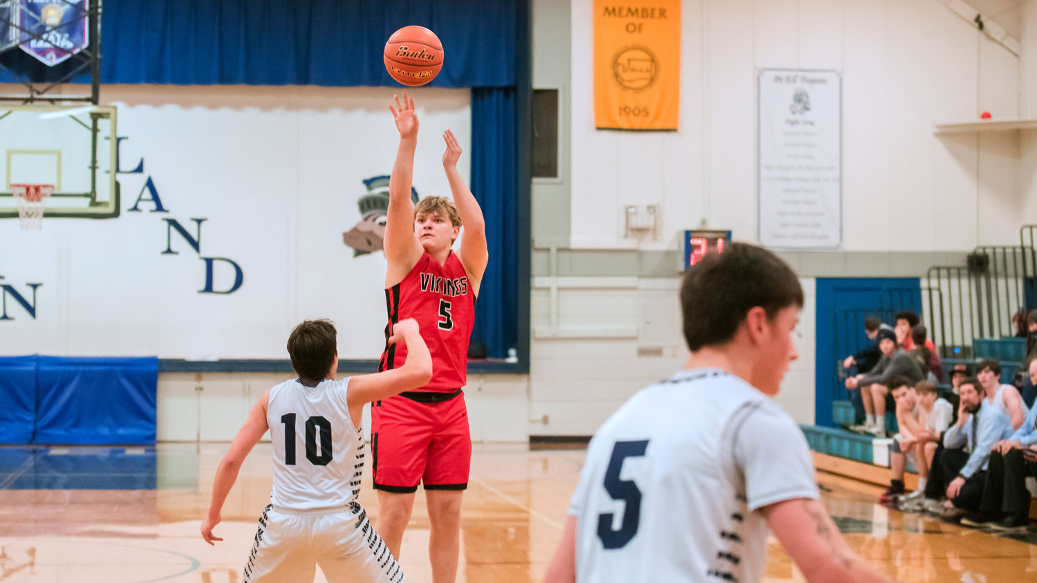Mossyrock’s Jake Comer (5) shoots over Pe Ell defenders during a game Wednesday night.