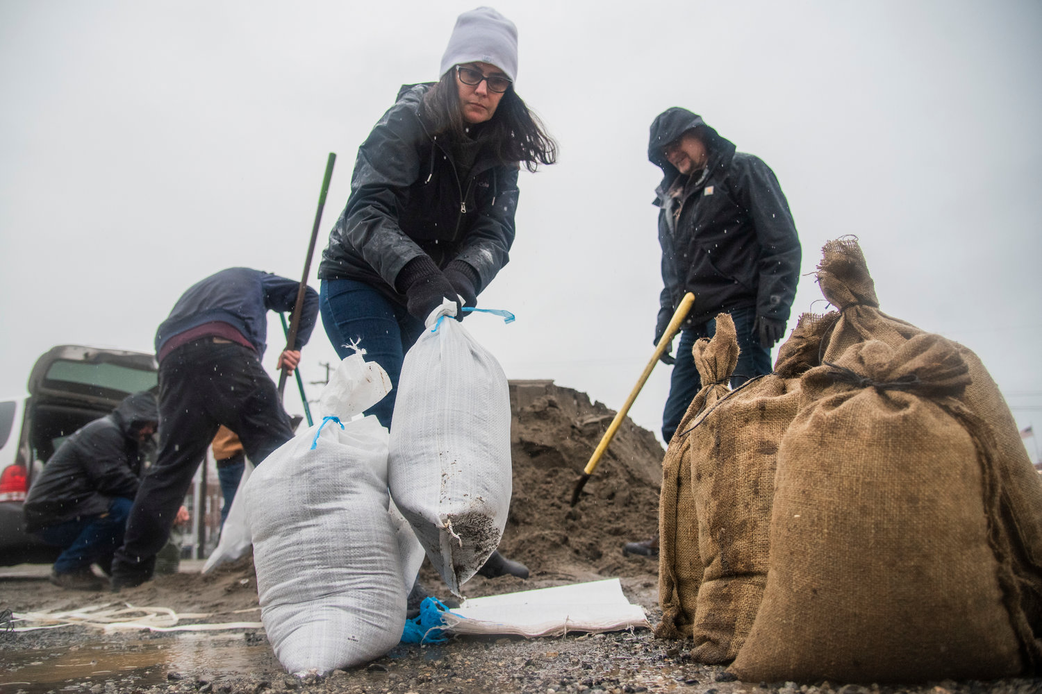 Dee and Jim Masters fill sandbags for their daughter who lives along Military Road in Centralia Thursday morning.