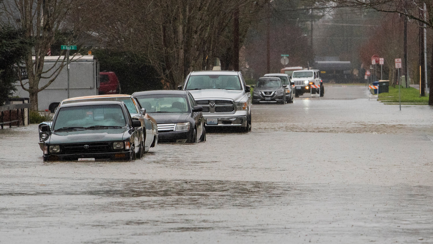 Floodwaters from China Creek surround cars parked along West Pine Street in Centralia on Thursday.