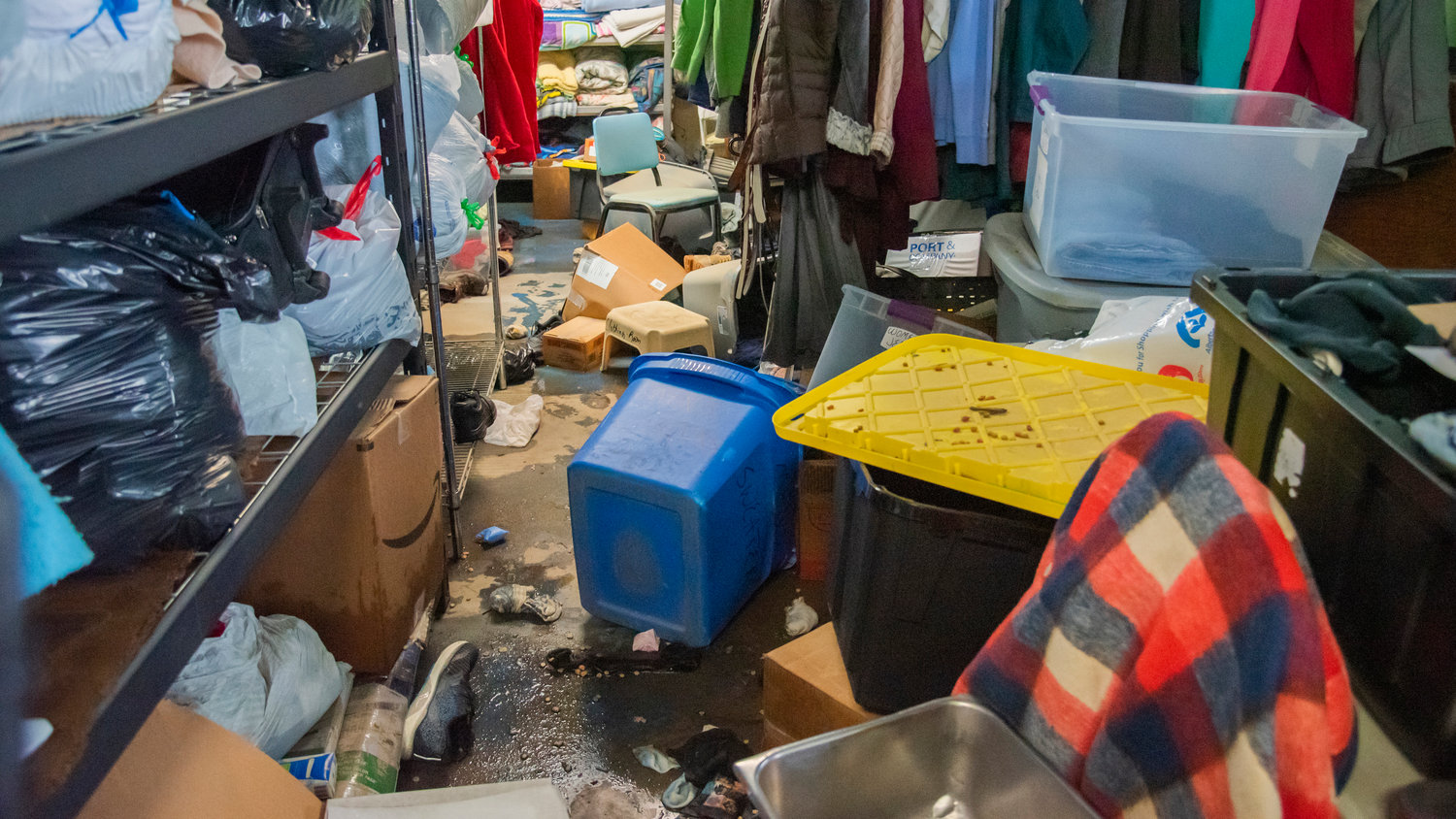 Boxes of donated clothing and animal food are seen scattered on Monday after flood waters toppled shelves and items stacked inside Lewis County Gospel Mission.