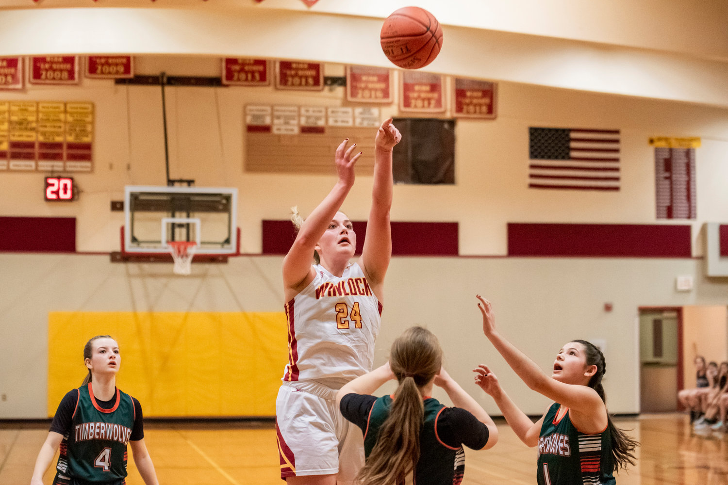 Winlock’s Addison Hall (24) scores over Timberwolves as they defend during a game Tuesday night.