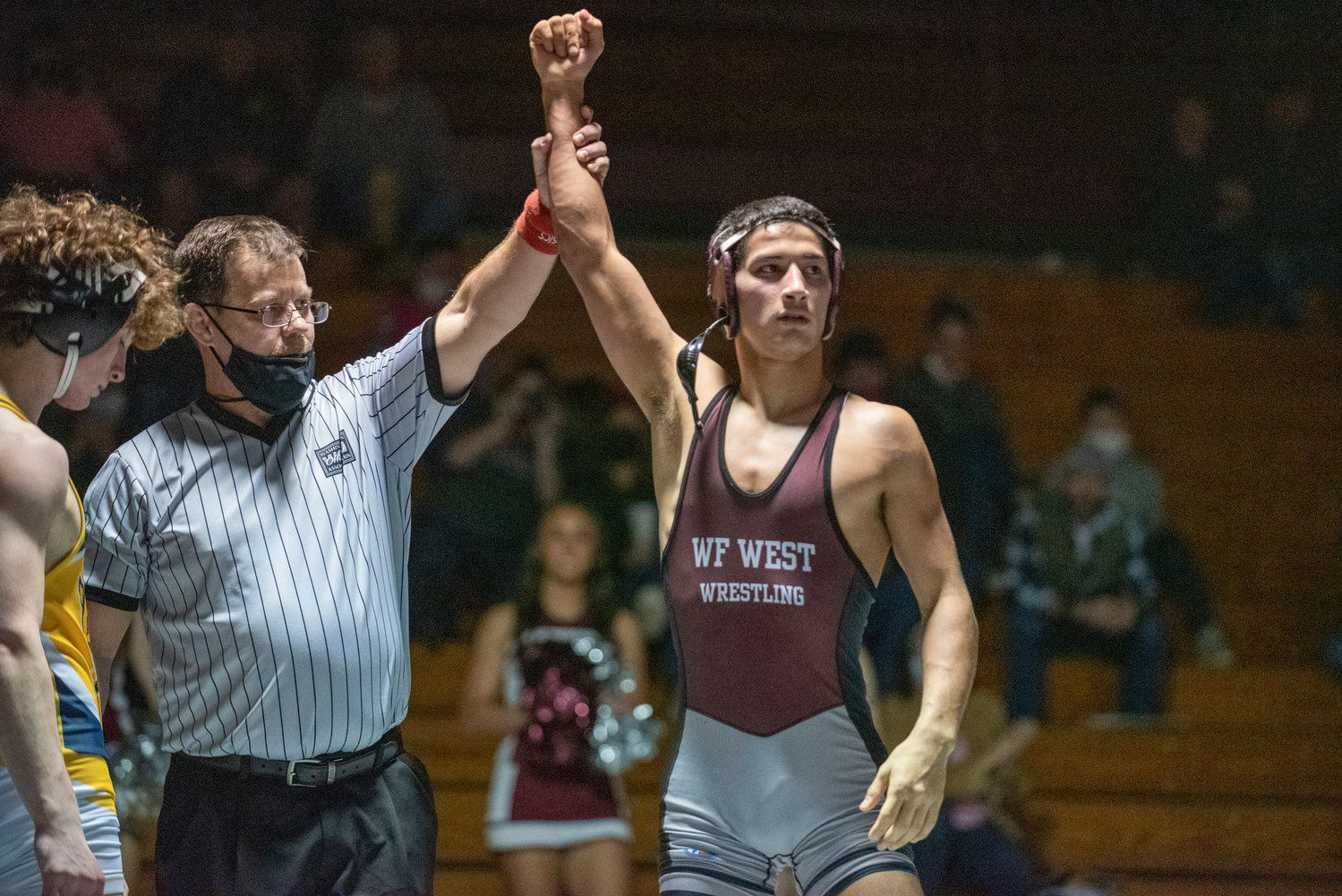 W.F. West's Bo Davis raises his hand in victory after defeating Aberdeen's Michael Leonteyv at 132 pounds during a home dual match on Jan. 12.