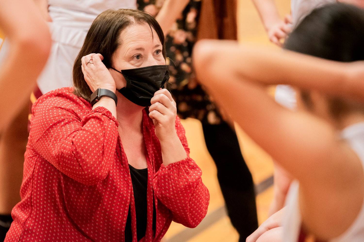 Winlock Head Coach Dracy McCoy adjusts her mask while talking to athletes courtside during a game against Stevenson.