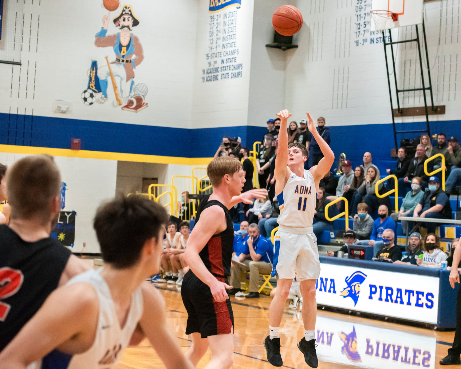 Adna’s Chase Collins (11) shoots from deep during a game against Rainier Friday night.