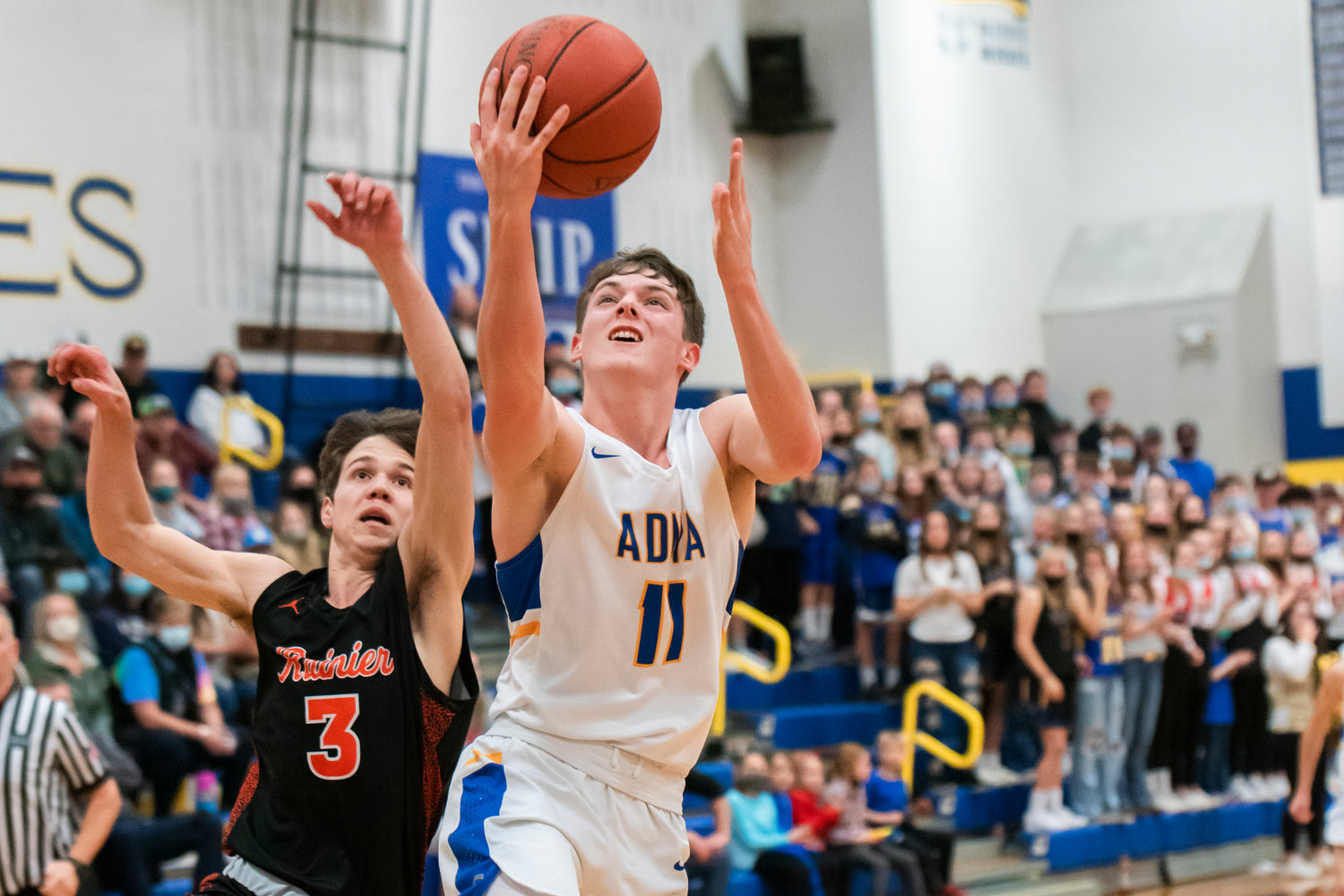 Adna’s Chase Collins (11) goes up with the ball during a game against Rainier Friday night.