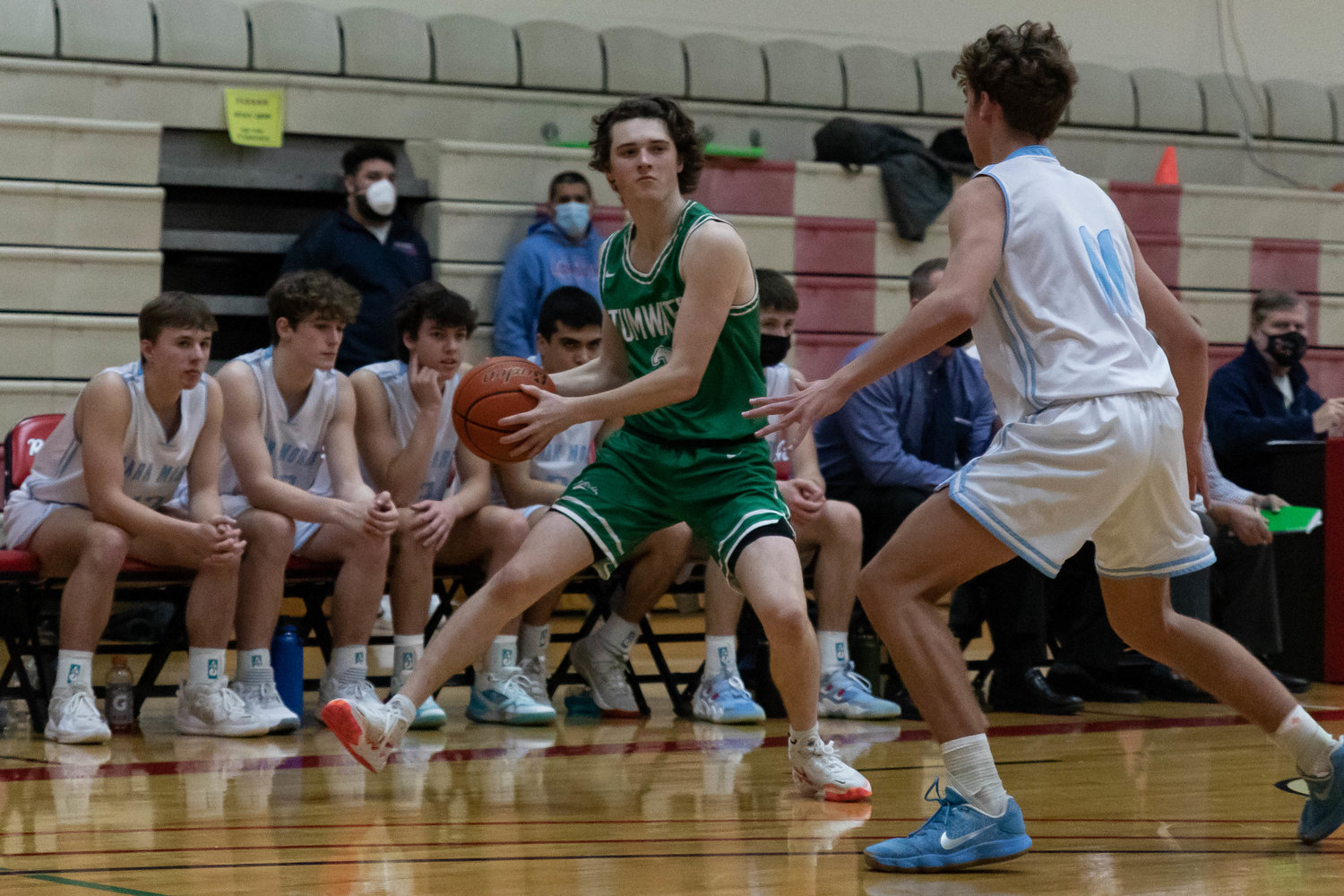 Tumwater guard Luke Reid throws an entry pass to the post against Mark Morris at the MLK Tribute in Longview at Lower Columbia Community College Jan. 17.