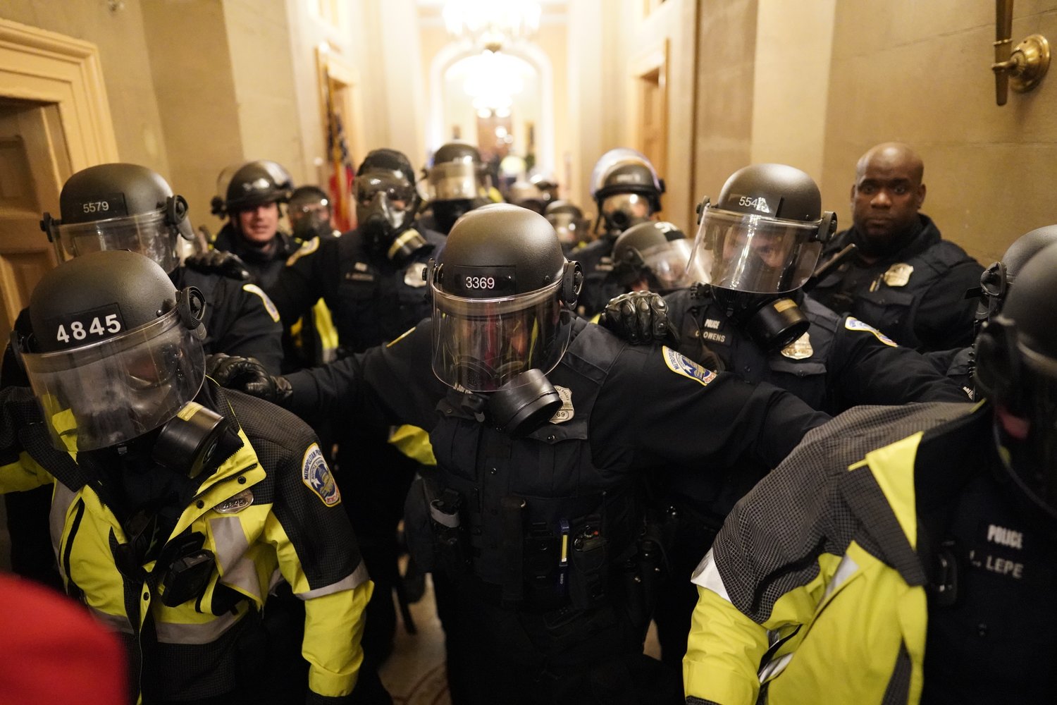 Riot police clear the hallway inside the Capitol on Wednesday, Jan. 6, 2021, in Washington, D.C. (Kent Nishimura/Los Angeles Times/TNS)