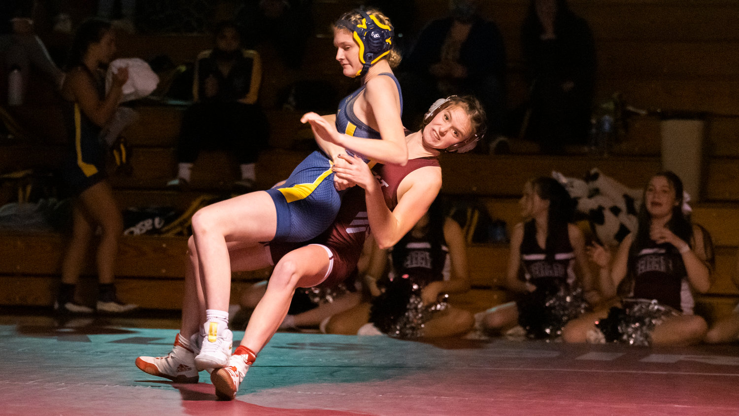 W.F. West Senior Elizabeth Patana brings down her opponent during a wrestling match Thursday night in Chehalis.