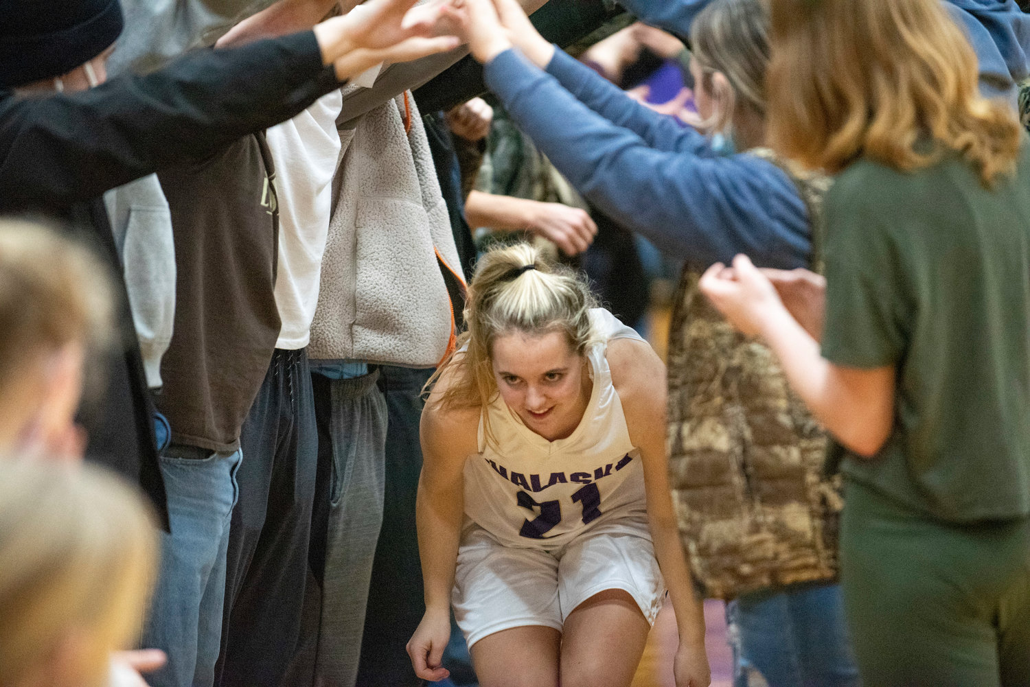 Onalaska's Callie Lawrence runs through a student-section tunnel during pre-game announcements on Jan. 20.