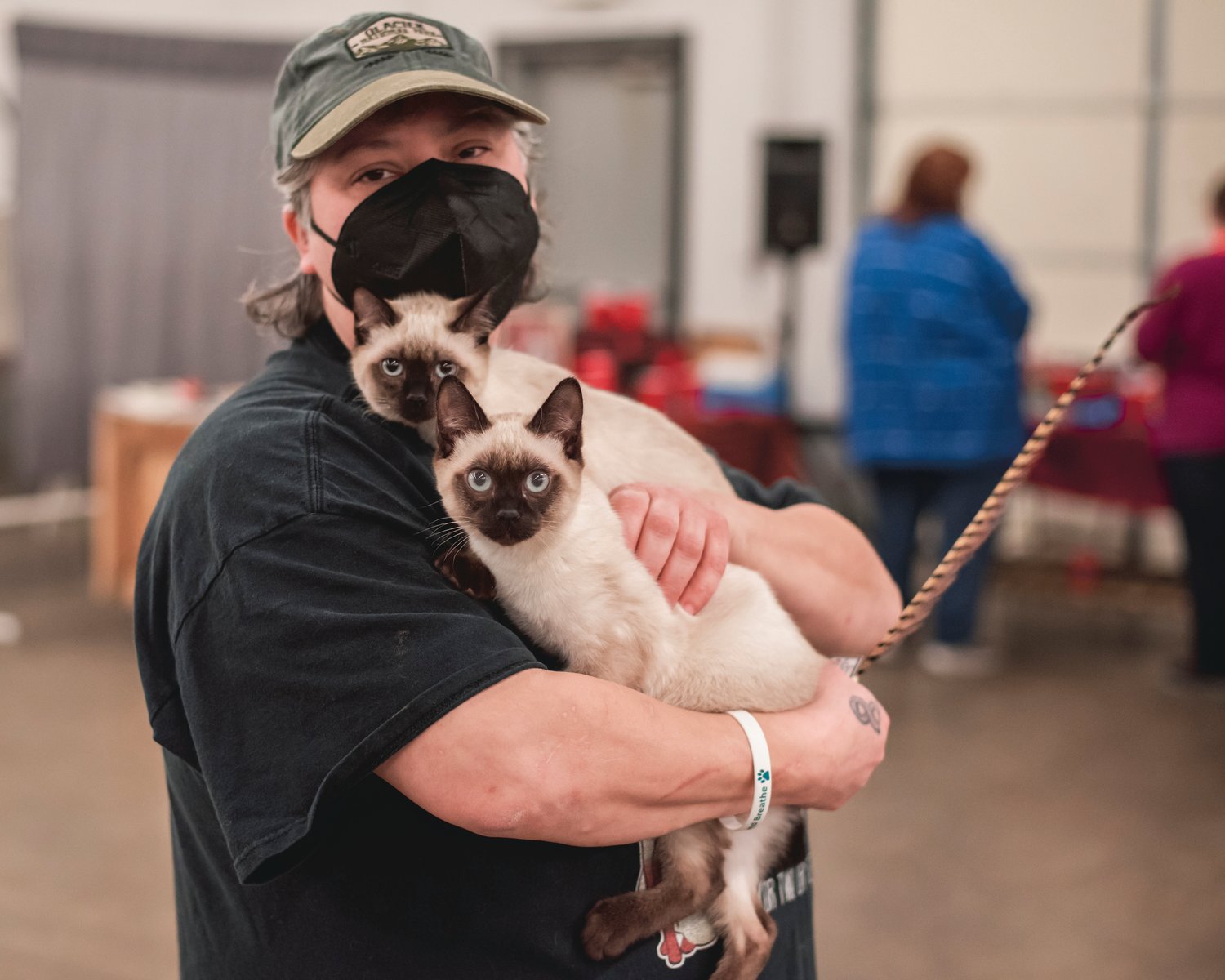 Jeanette McLeese carries two kittens named Bob and Deziray through the Southwest Washington Fairgrounds in Centralia on Sunday.