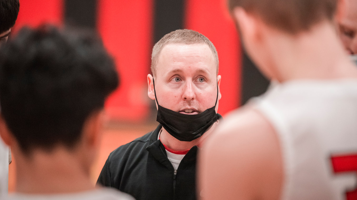 Mossyrock Head Coach Adam Deck talks to players Monday night during a game against Onalaska.
