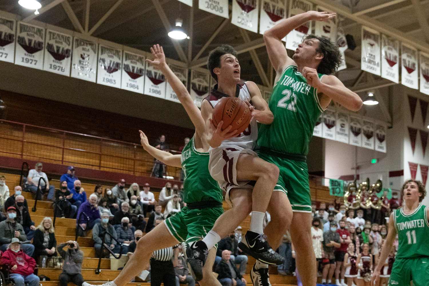 W.F. West guard Seth Hoff is fouled by Tumwater's Ryan Otton on a drive attempt Jan. 25.