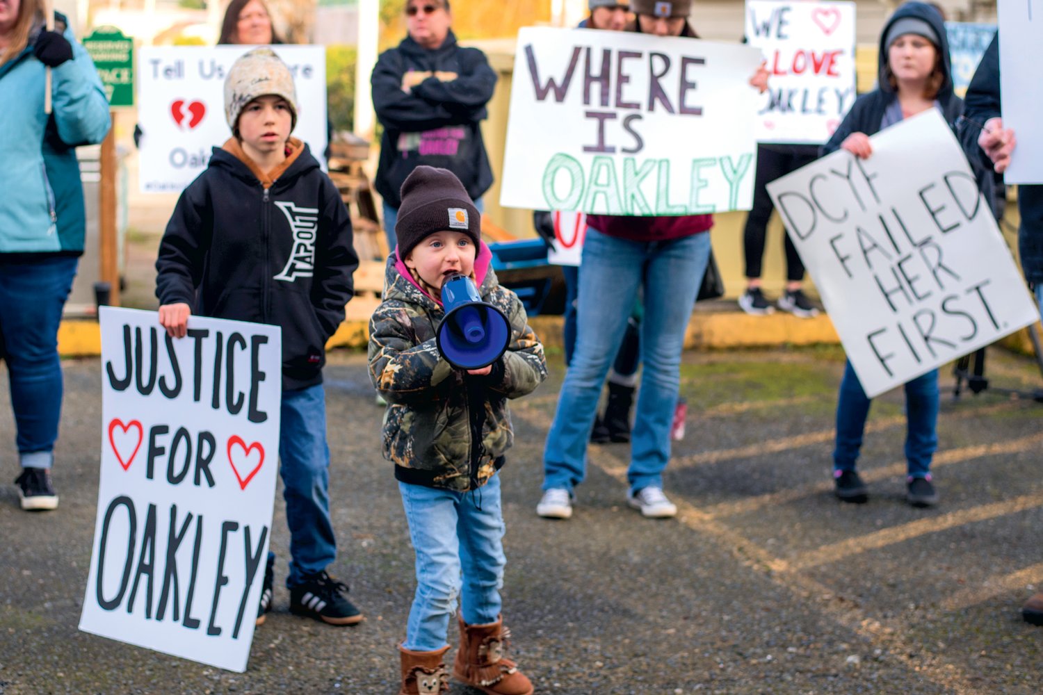 Aubrey Wolfe, 5, stands next to her brother Easton, 10, while yelling into a megaphone outside the Grays Harbor County Correctional Facility during a demonstration for missing Oakley Carlson Saturday in Montesano.