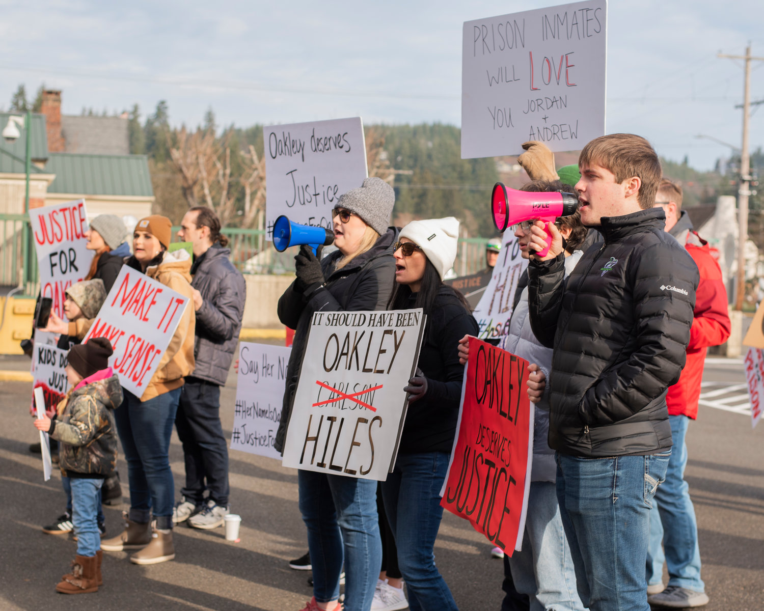 Foster mom Jaime Jo Hiles stands alongside demonstrators with signs and megaphones outside the Grays Harbor County Correctional Facility Saturday in Montesano.