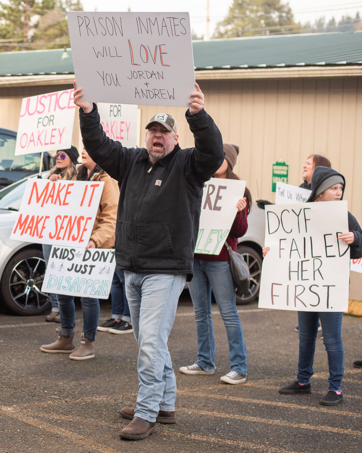 Eathan Cooperrider holds a sign and yells alongside demonstrators outside the Grays Harbor County Correctional Facility Saturday in Montesano.