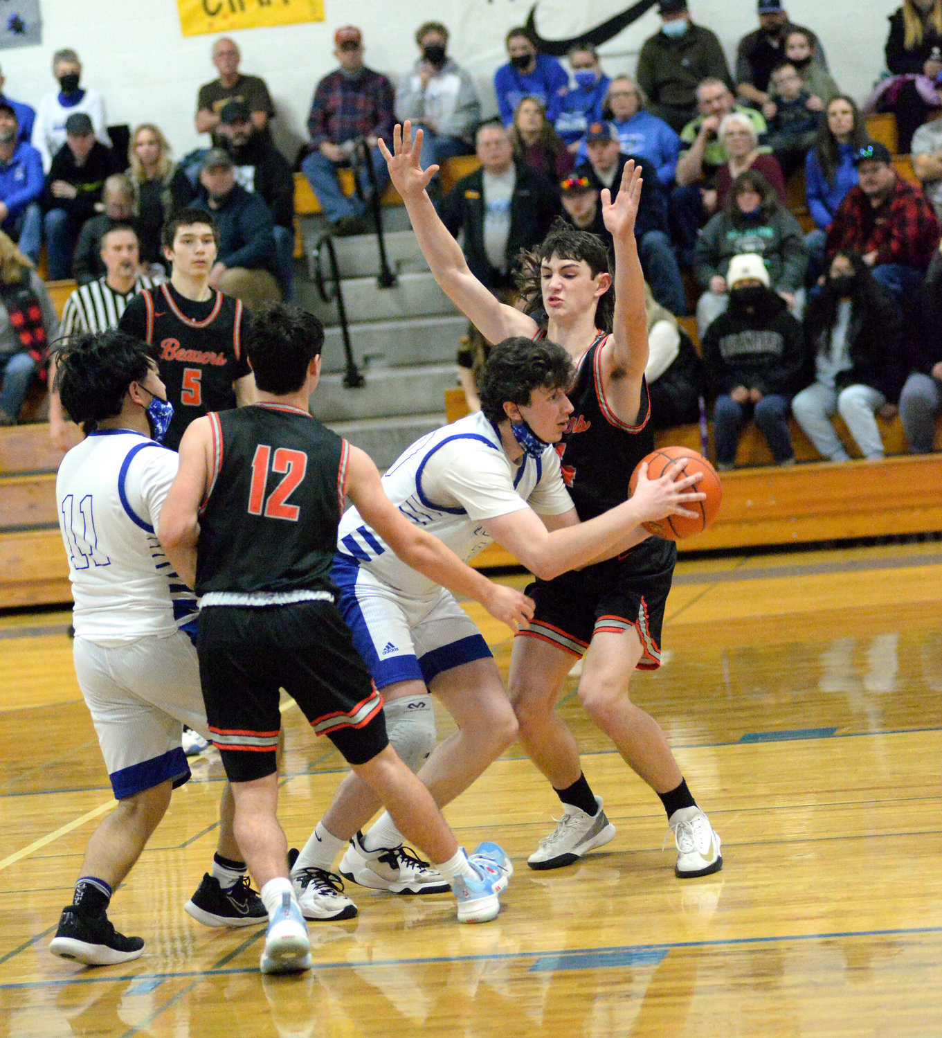 Tenino’s Brody Noonan, right, and Will Feltus defend against an Elma player during a road game on Tuesday.