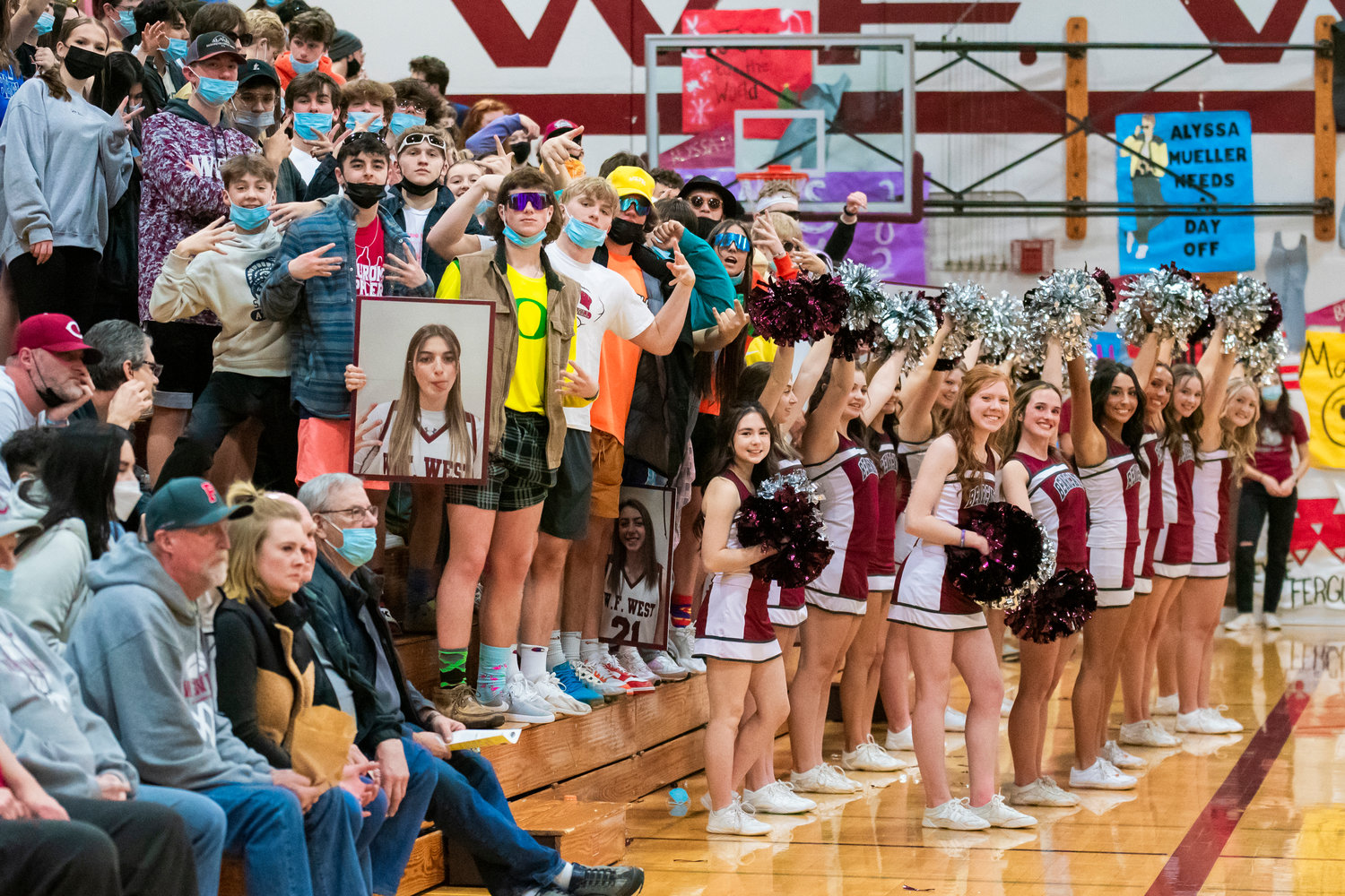 Bearcat fans and cheerleaders pose for photo as they lead the Tigers during a game at W.F. West High School in Chehalis Tuesday, February 1, 2022.