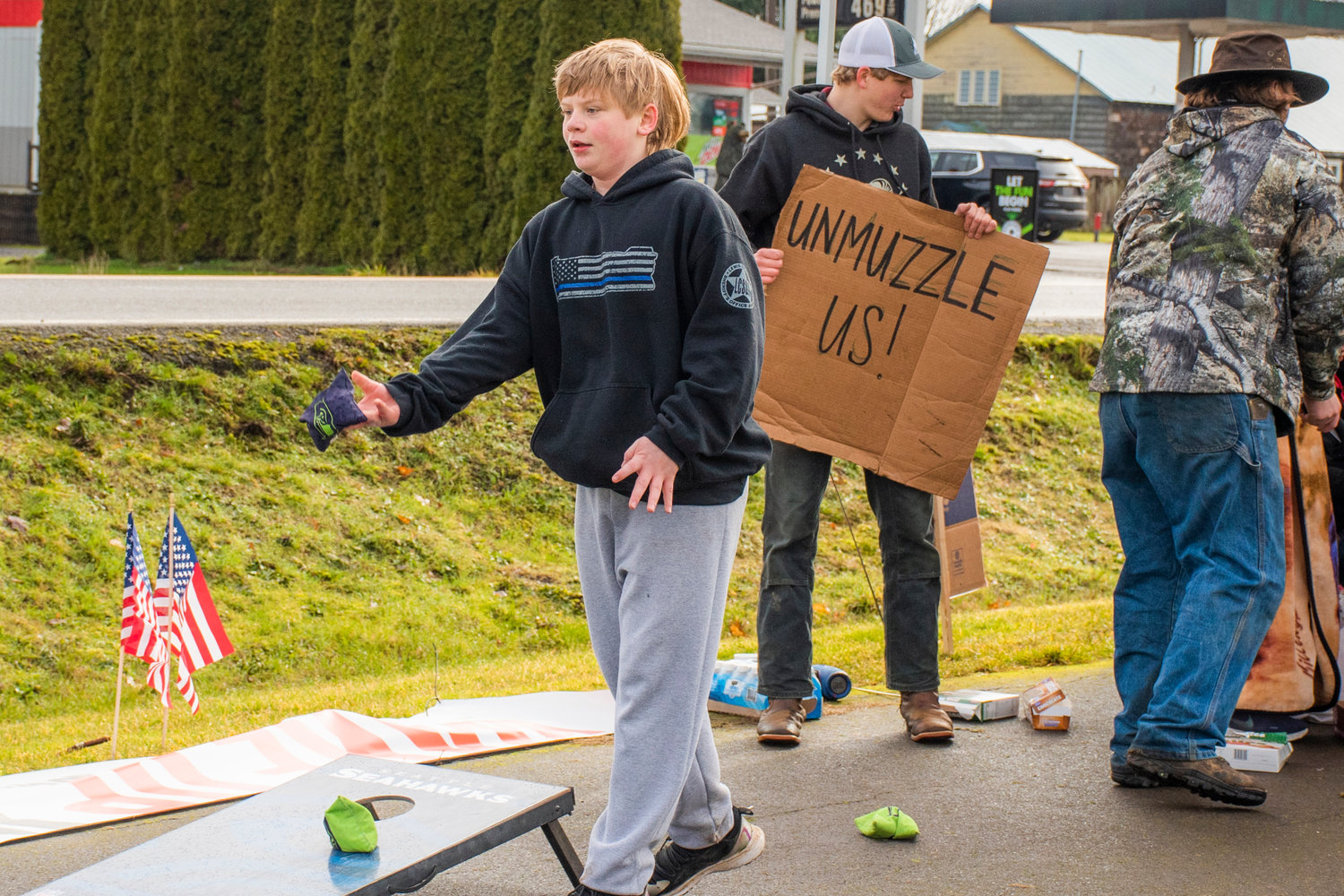 Braxton Corder, a middle school student, plays cornhole during a demonstration Wednesday outside the Pe Ell School District building.