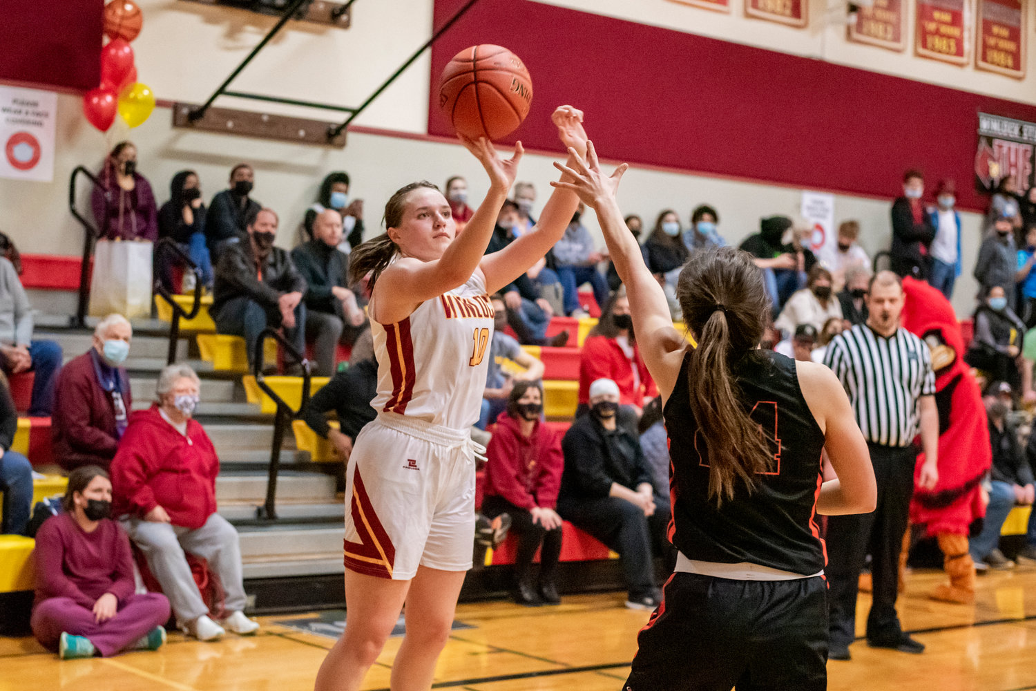 Winlock’s Madison Vigre (10) scores over a Rainier defender during a game Wednesday night.