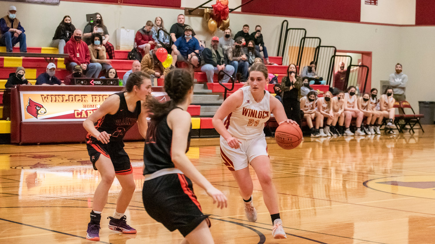 Winlock’s Addison Hall (24) dribbles in on defenders during a game against Rainier Wednesday night at Winlock High School.