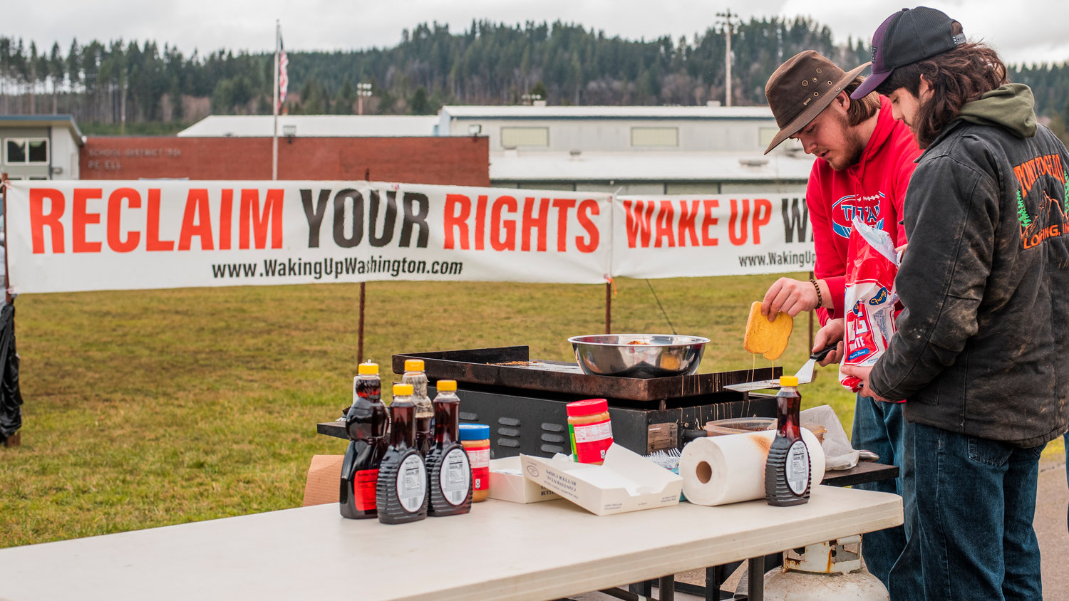 Students prepare french toast while protesting the mask mandate Friday outside the Pe Ell School District building.