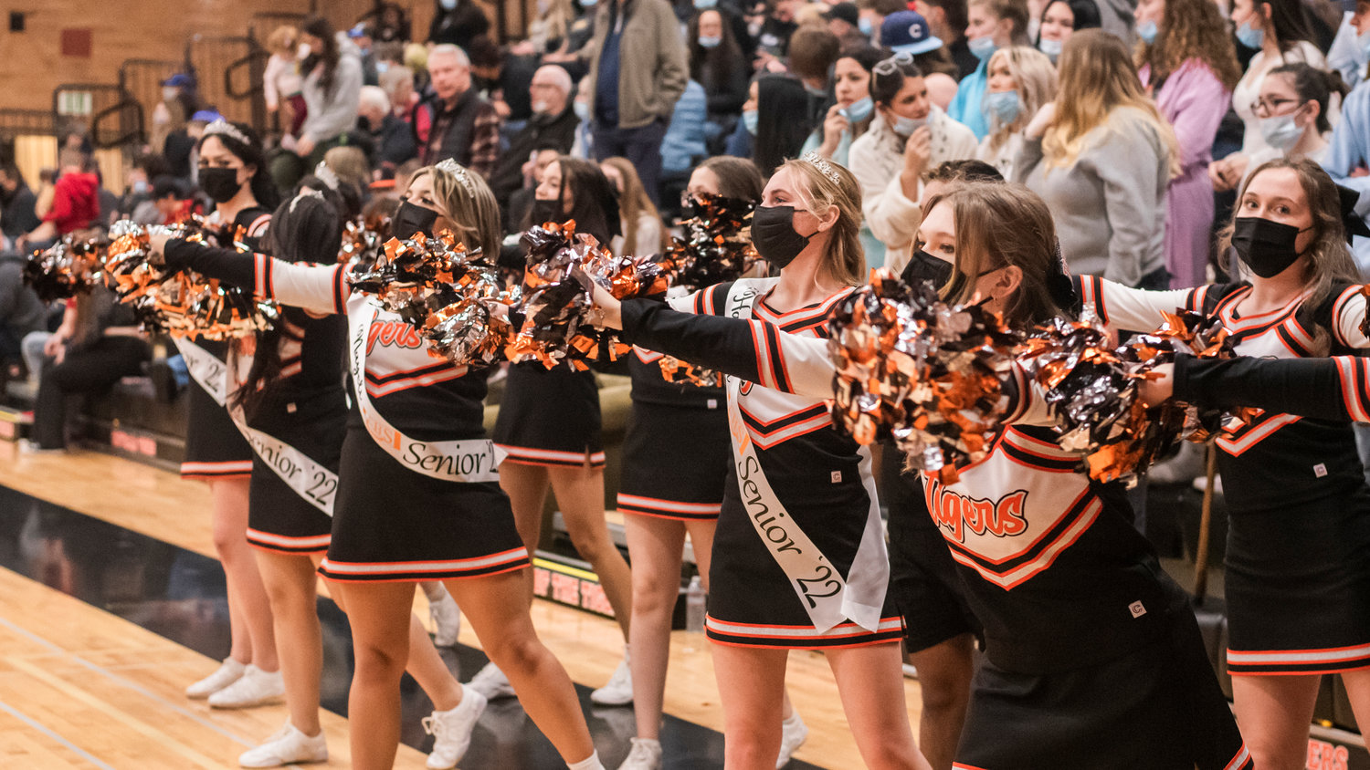 Seniors sport sashes and tiaras while cheering for Tigers courtside during a boys basketball game Friday night at Centralia High School.