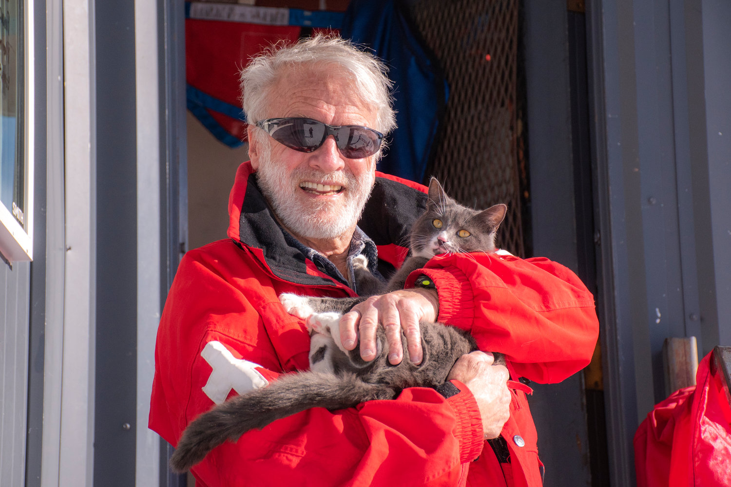 Michael Murphy, known on the slopes as “Murph” and his avalanche cat Uzi pose for a photo outside patrol dispatch at the top of the Great White Express chairlift on Sunday at the White Pass Ski Resort.