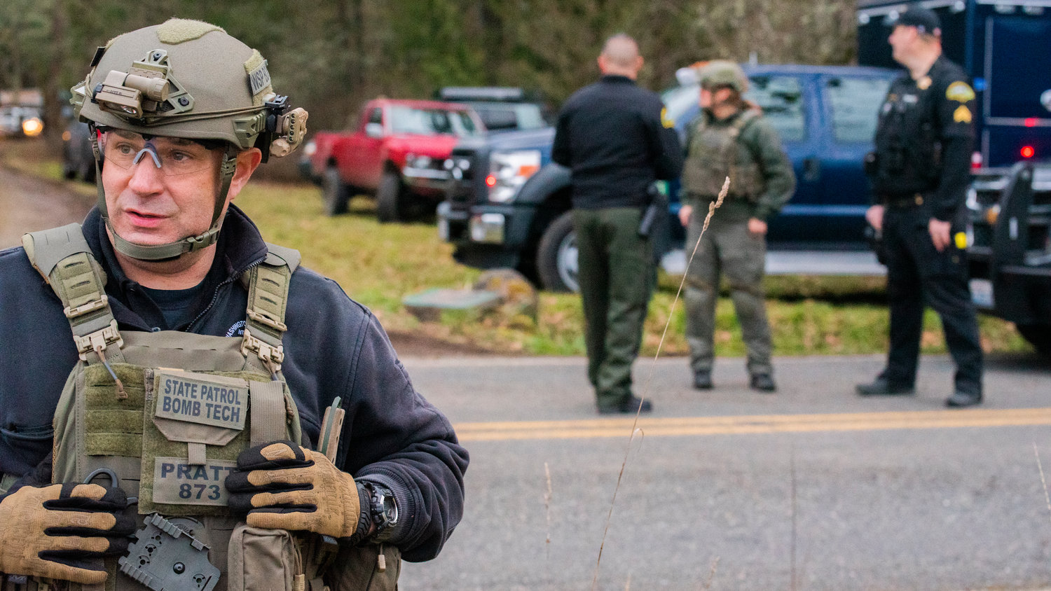 Washington State Patrol Bomb Squad Commander Clifford Pratt describes how responders are working to safely clear a Yelm residence of potentially dangerous materials by means of detonation in the 20000 block of Neat Road Southeast Tuesday afternoon.