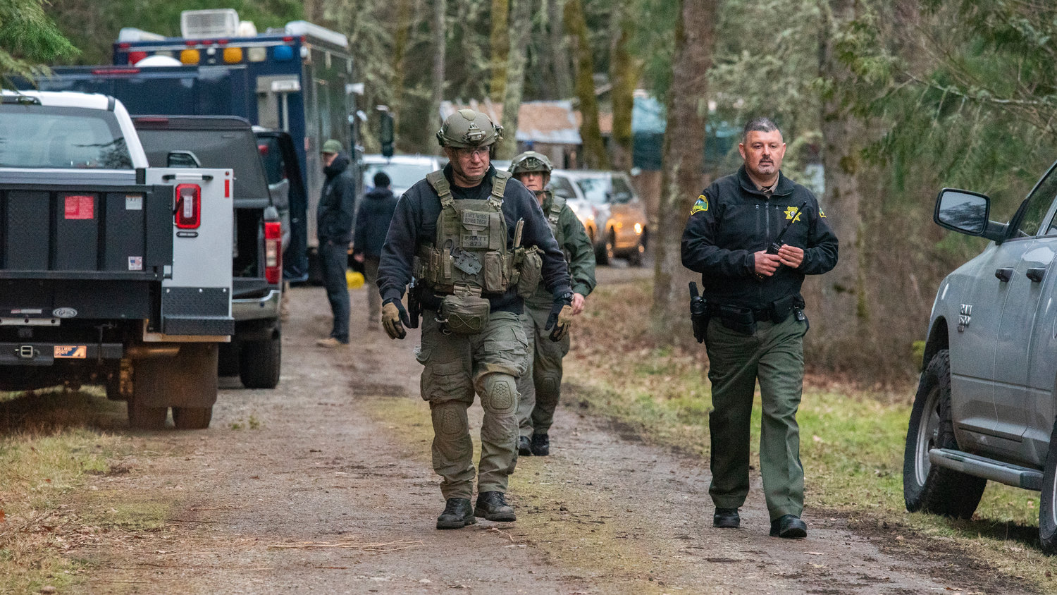 Washington State Patrol Bomb Squad Commander Clifford Pratt walks with another bomb tech and a Thurston County deputy while working to safely clear a Yelm residence of potentially dangerous materials by means of detonation in the 20000 block of Neat Road Southeast Tuesday afternoon.