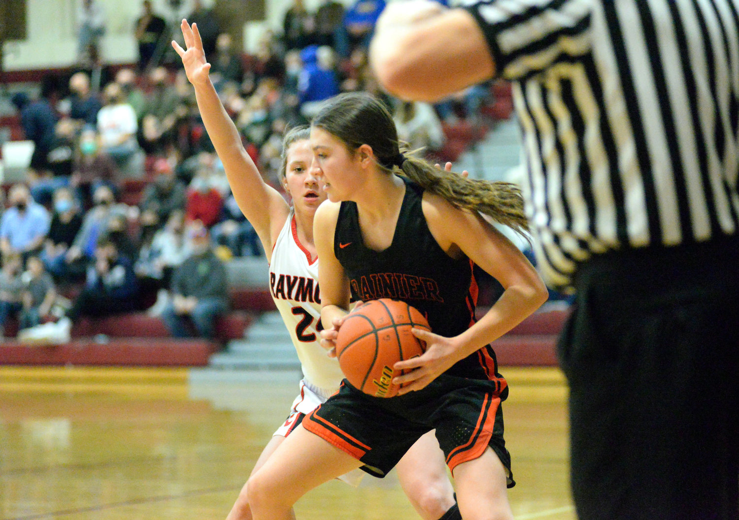Rainier's Olivia Earsley (14) and Bryn Beckman (24) defend a shot against Raymond's Kyra Gardner during the Mountaineers' 49-32 loss in the 2B District 4 quarterfinals on Tuesday in Montesano.
