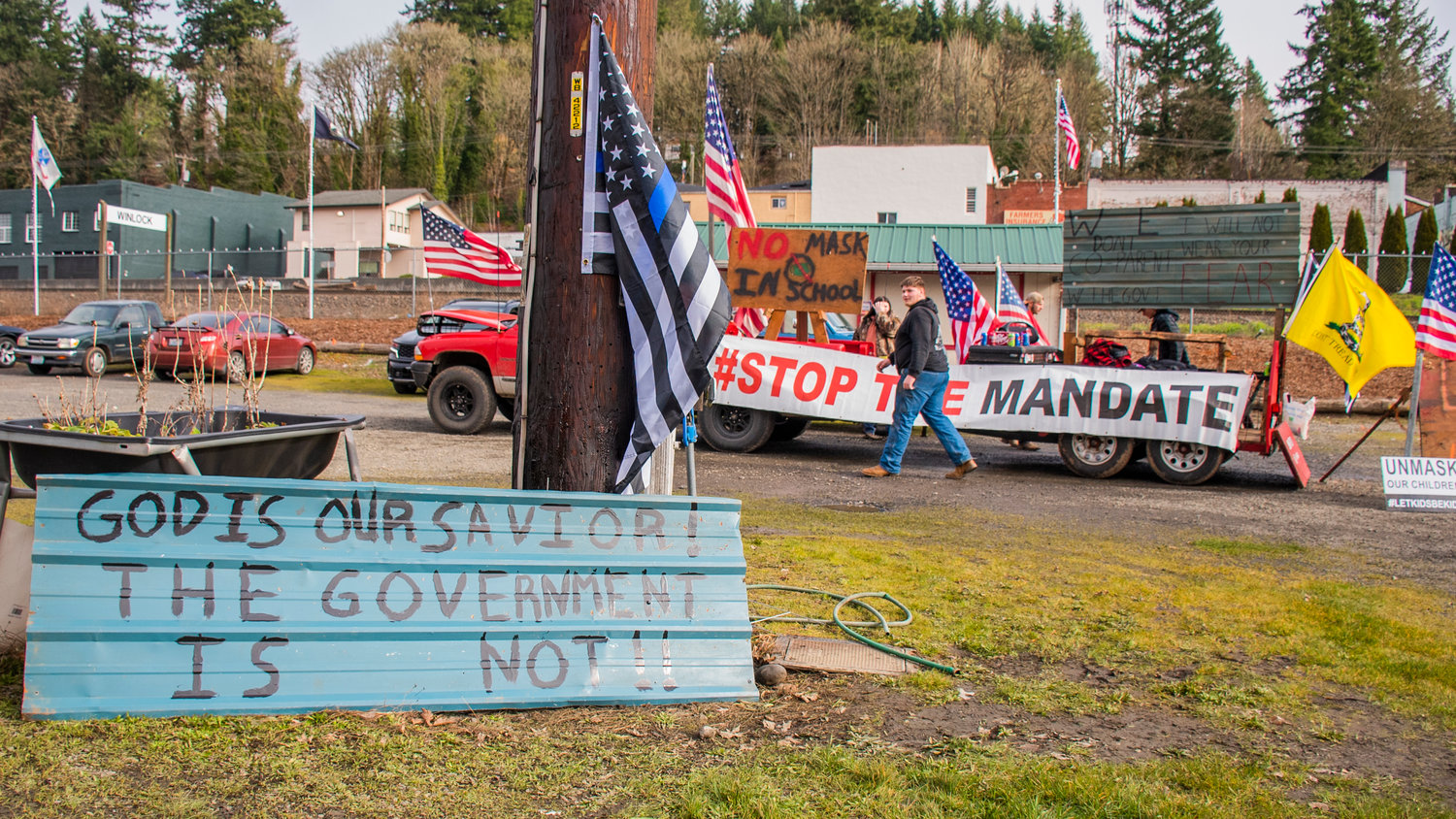 Signs written on sheet metal are displayed along Southwest Kerron Street in Winlock as students protest the mask mandate Tuesday afternoon.
