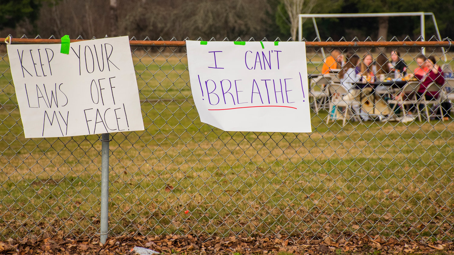 Middle School students eat outside as signs display messages during a student lead protest in Onalaska Wednesday morning.