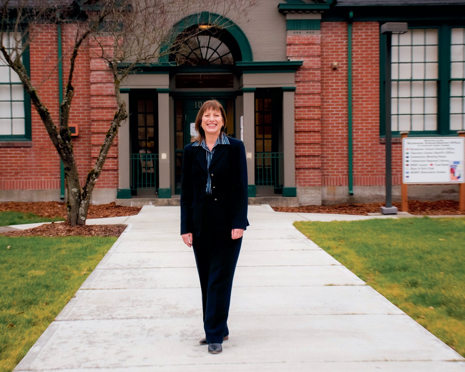 Outgoing Rochester Superintendent Kim Fry smiles for a photo outside the district office Thursday afternoon.