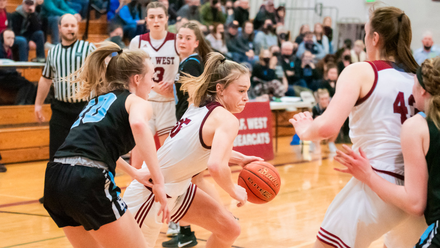 W.F. West senior Kyla McCallum (25) dribbles around defenders during a game Friday night in Chehalis.