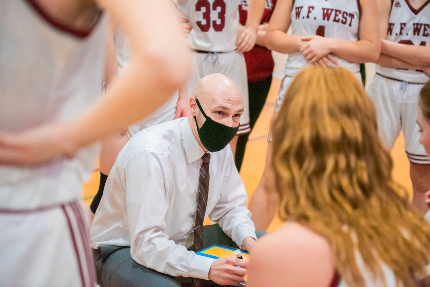 Bearcat Head Coach Kyle Karnofski talks to athletes courtside during a game at W.F. West Friday night.