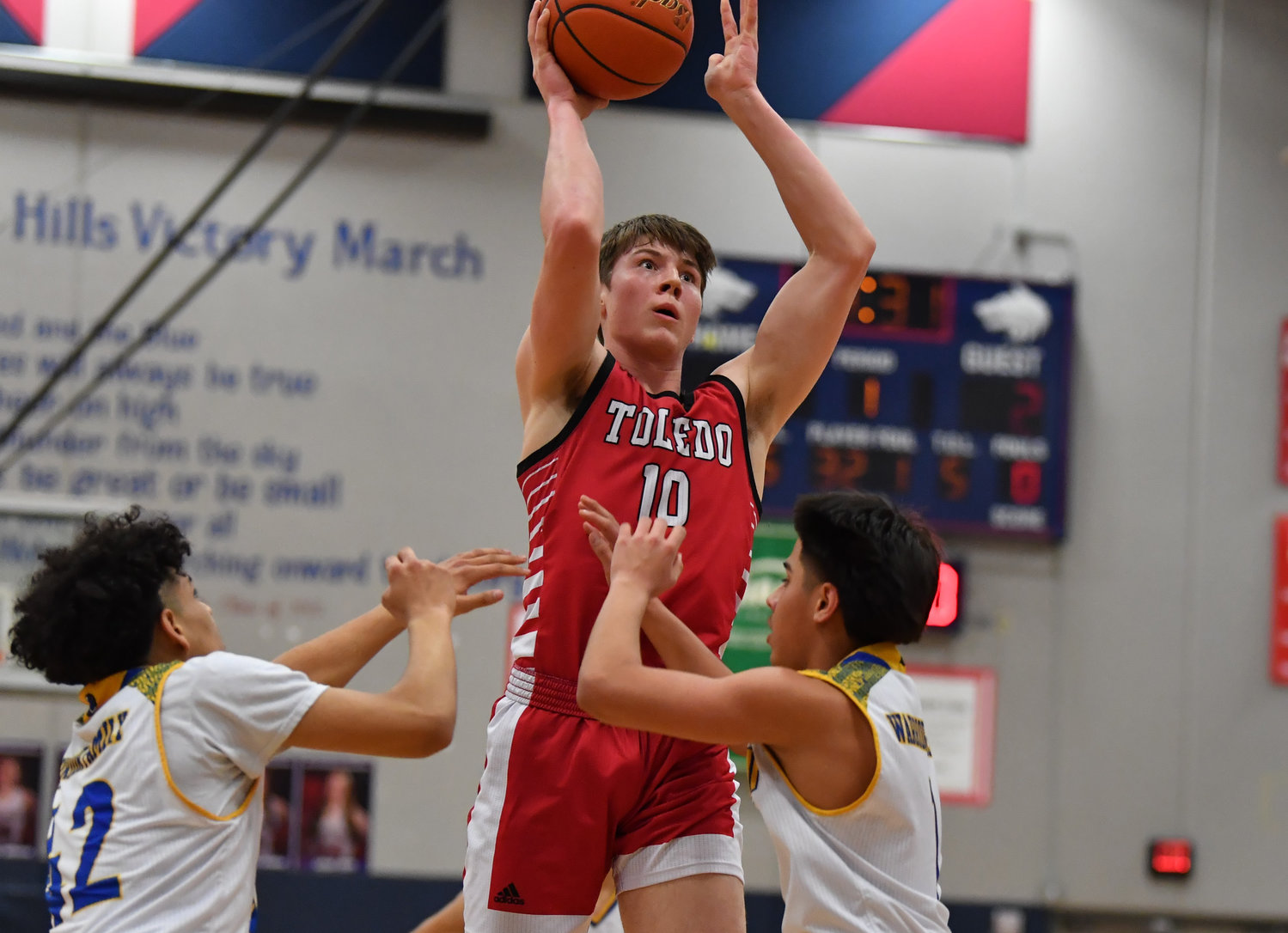 Toledo’s Carson Olmstead shoots over two Chief Leschi players in the district playoffs at Black Hills High School on Feb. 11.