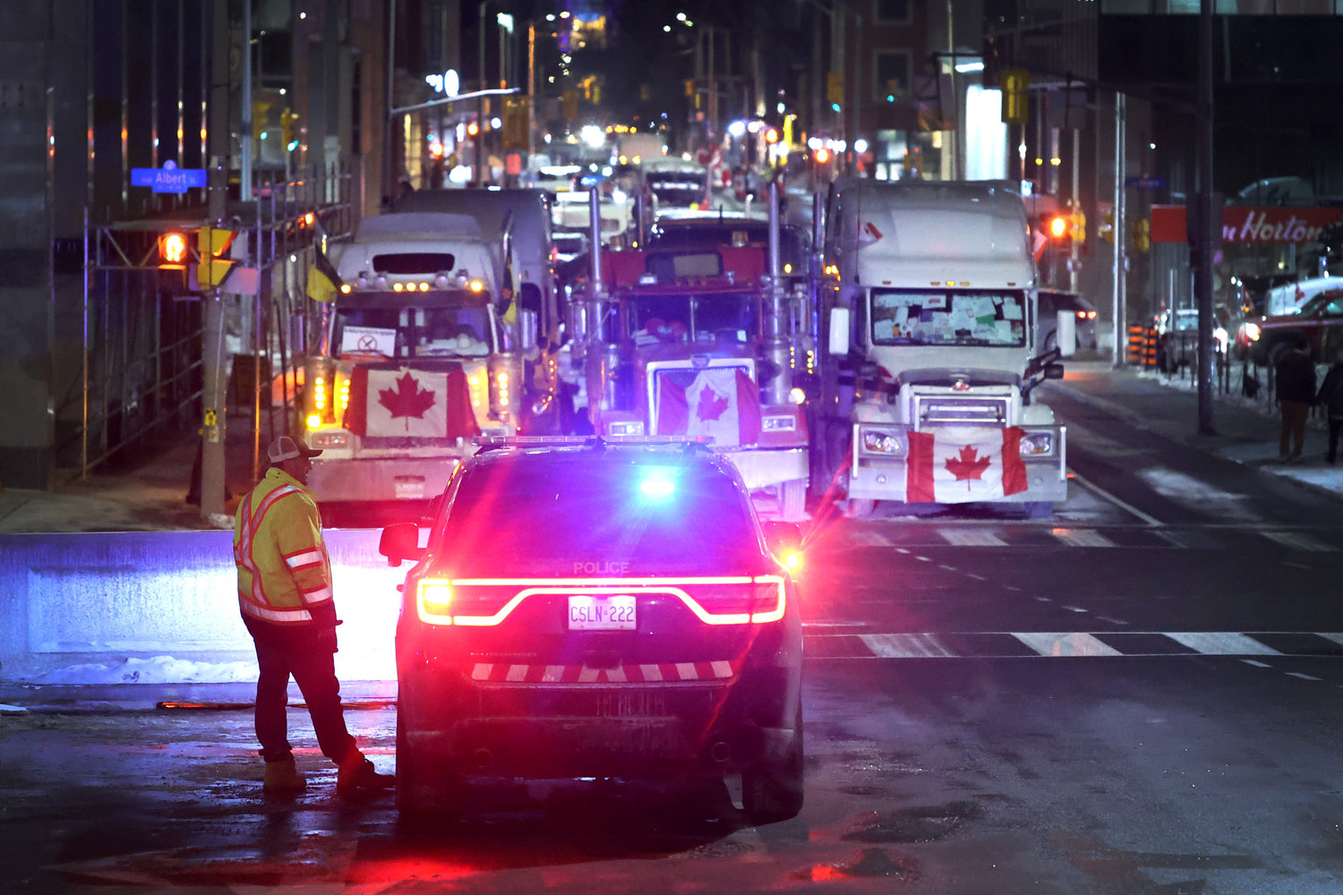 A police vehicle blocks a downtown street to prevent trucks from joining a blockade of truckers protesting vaccine mandates near the Parliament Buildings on Feb. 15, 2022, in Ottawa, Canada. (Scott Olson/Getty Images/TNS)