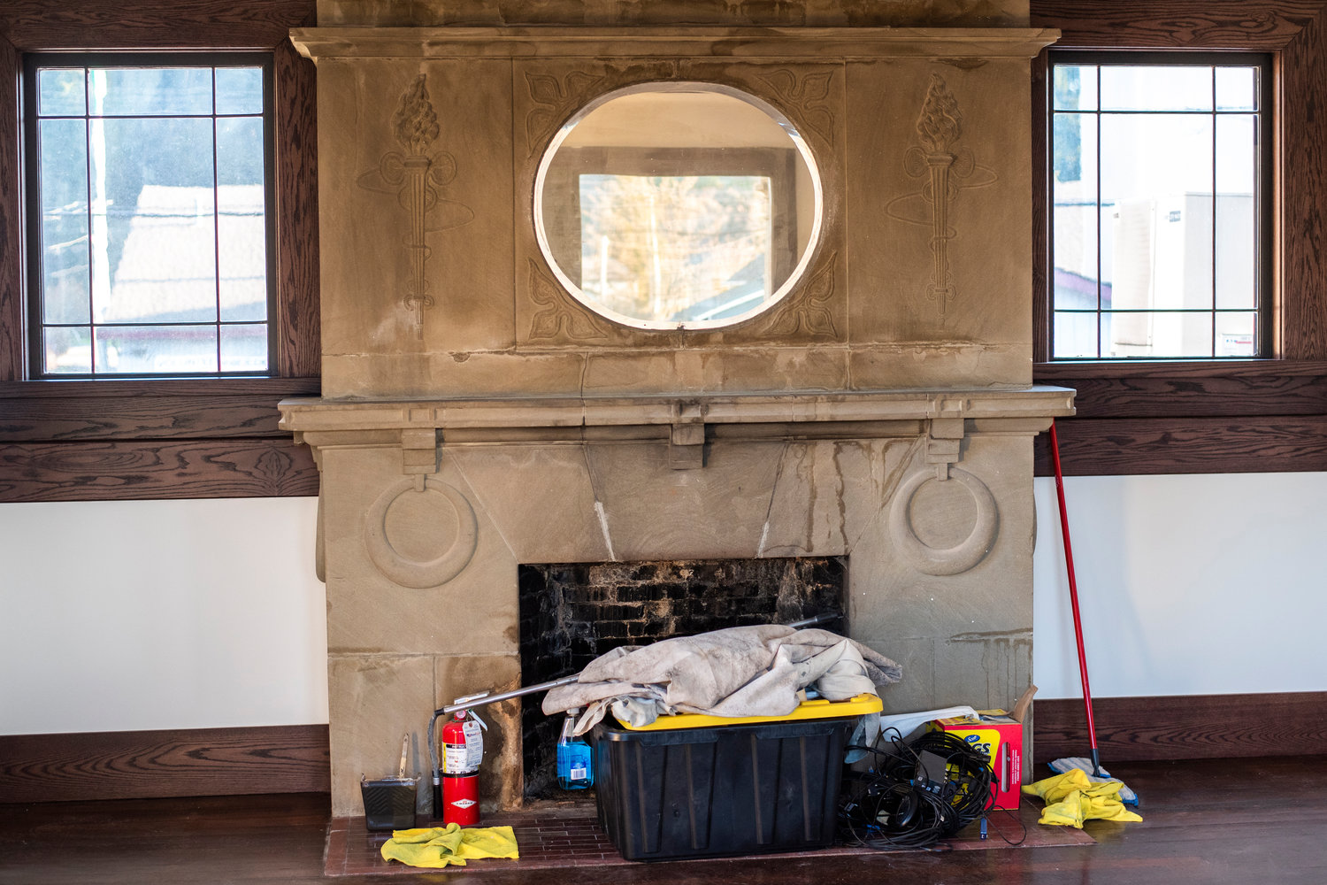 Newly installed window frames tuck into the corners of a vintage fireplace inside Tenino City Hall during a remodel.