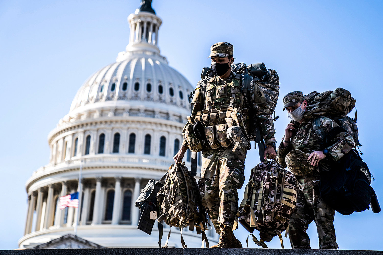 Members of the National Guard carry supplies near the U.S. Capitol on Jan. 14, 2021. Capitol Police and D.C. government officials have requested the National Guard’s assistance with a truck convoy headed to Washington, D.C. (Kent Nishimura/Los Angeles Times/TNS)